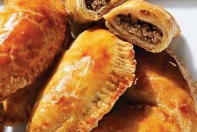 Close-up view of beef empanadas on a plate.
